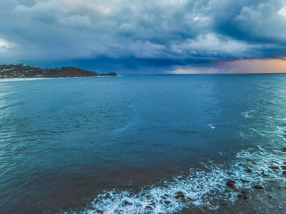 Rain clouds and storm light sunrise seascape