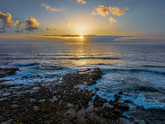 Sunrise over the ocean and rock platform