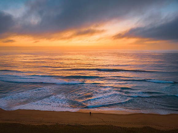 Summer sunrise at the seaside with clouds and haze