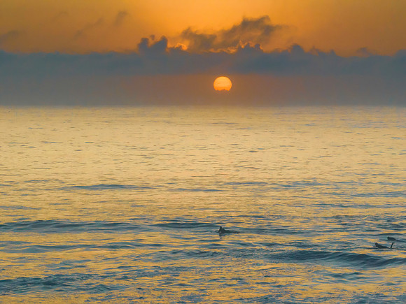 Summer sunrise at the seaside with clouds and haze