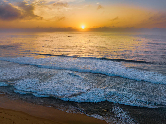 Summer sunrise at the seaside with clouds and haze