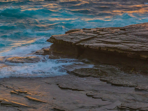 Top down sunrise view of sea and rock platform