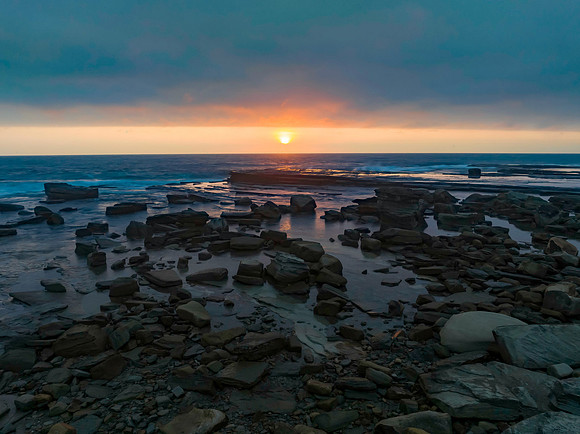 Hazy Summer Sunrise Seascape and Rocky Inlet