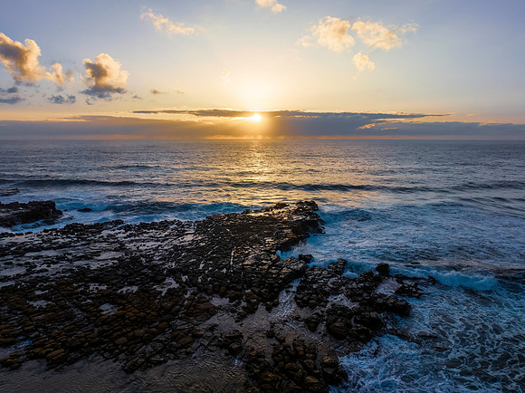Sunrise over the ocean and rock platform