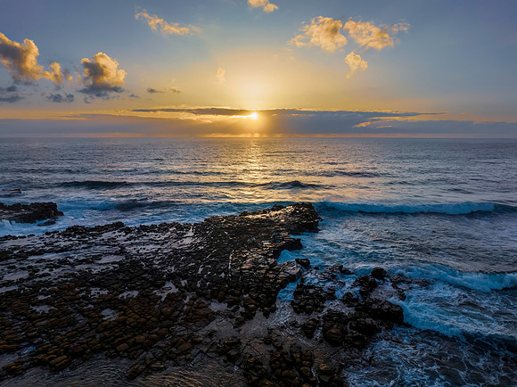 Sunrise over the ocean and rock platform