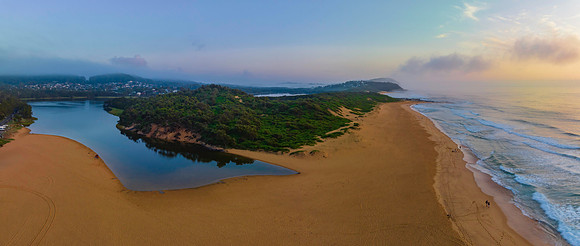 Summer sunrise panorama at the beach and lagoon with clouds and