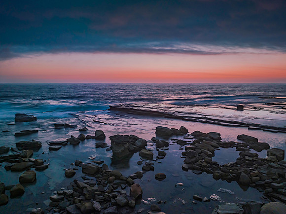 Hazy Summer Sunrise Seascape and Rocky Inlet