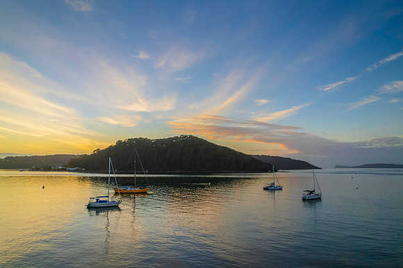 Aerial sunrise waterscape with boats