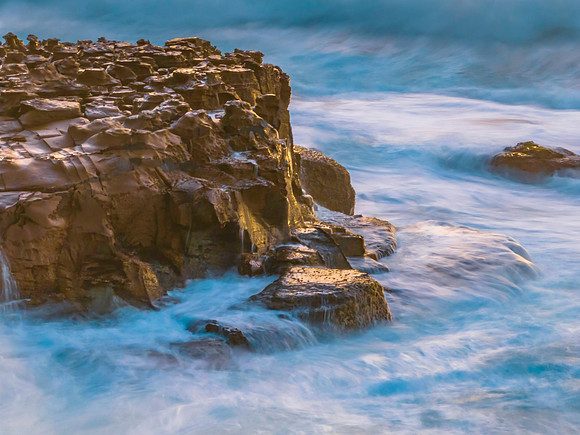 Dawn at the seaside with cascades over the rock platform