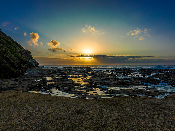 Sunrise over the ocean and rock platform