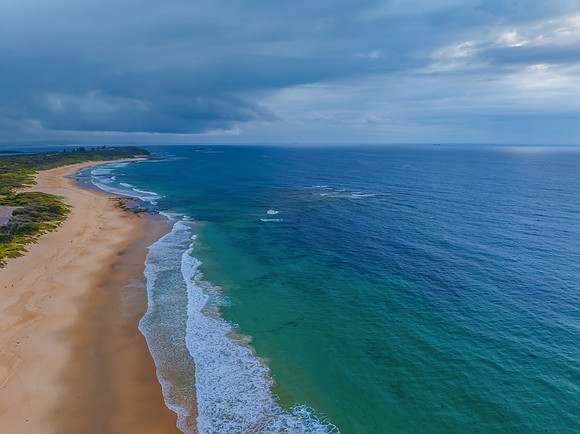 Sunrise Seascape with beautiful cloud covered sky and gentle sur
