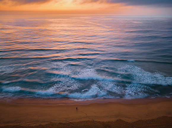 Summer sunrise at the seaside with clouds and haze