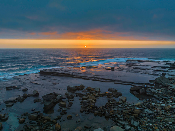 Hazy Summer Sunrise Seascape and Rocky Inlet