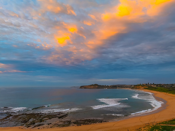 Sunrise Seascape  with Calm Seas and a Cloud Covered Sky