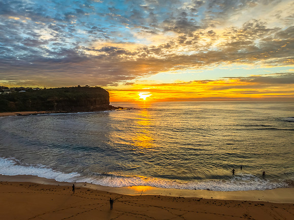 Sunrise Seascape  with Calm Seas and a Cloud Covered Sky