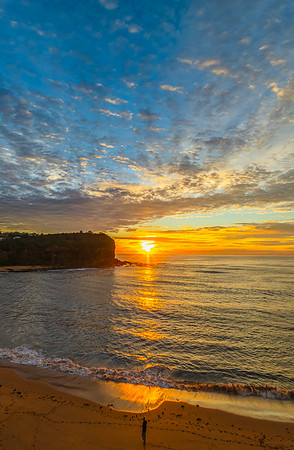 Sunrise Seascape  with Calm Seas and a Cloud Covered Sky