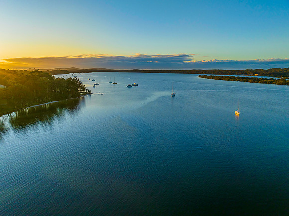 Sunrise over the river with boats