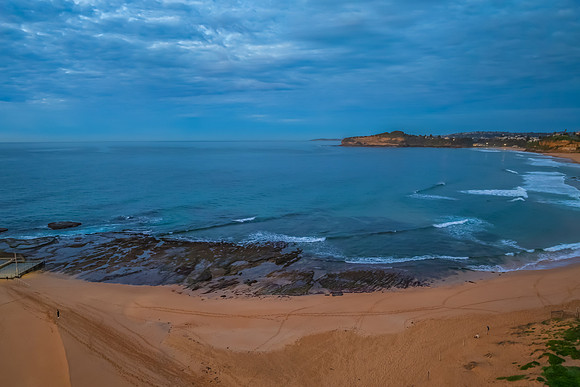 Sunrise Seascape  with Calm Seas and a Cloud Covered Sky
