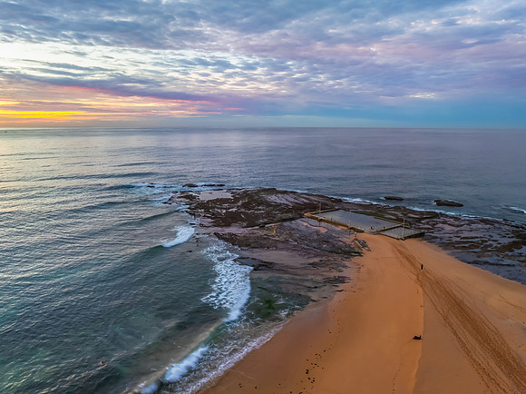 Sunrise Seascape  with Calm Seas and a Cloud Covered Sky