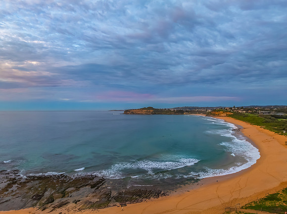 Sunrise Seascape  with Calm Seas and a Cloud Covered Sky