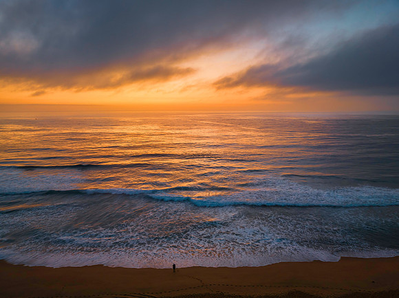 Summer sunrise at the seaside with clouds and haze