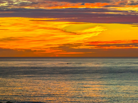Sunrise Seascape  with Calm Seas and a Cloud Covered Sky