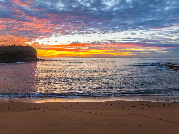 Sunrise Seascape  with Calm Seas and a Cloud Covered Sky