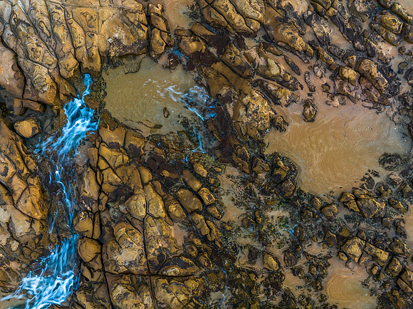 Top down view over tessellated rock platform at the seaside