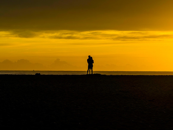 Sunrise silhouettes - golden hour romance at the seaside