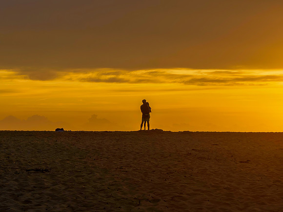 Sunrise silhouettes - golden hour romance at the seaside
