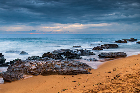 Sunrise at the seaside with rocks and beautiful diffused light b