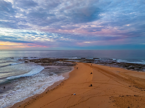 Sunrise Seascape  with Calm Seas and a Cloud Covered Sky