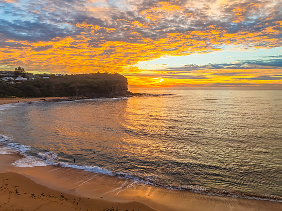 Sunrise Seascape  with Calm Seas and a Cloud Covered Sky