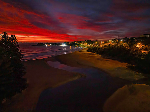 High cloud sunrise at the seaside with street lights and reflect