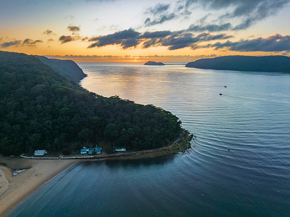 Sunrise views over the bay with boats and mountain ranges from P