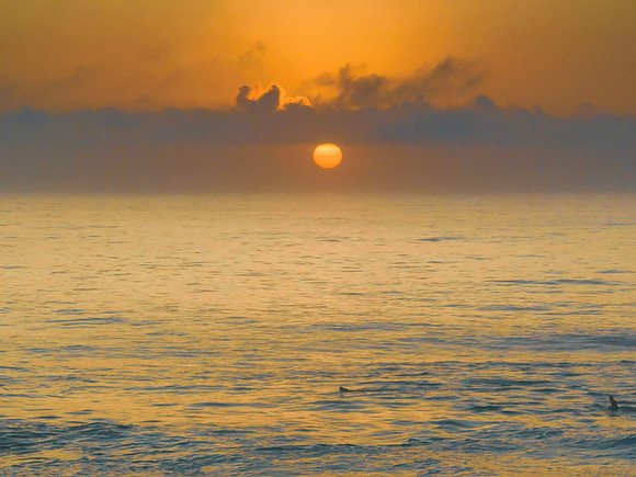 Summer sunrise at the seaside with clouds and haze