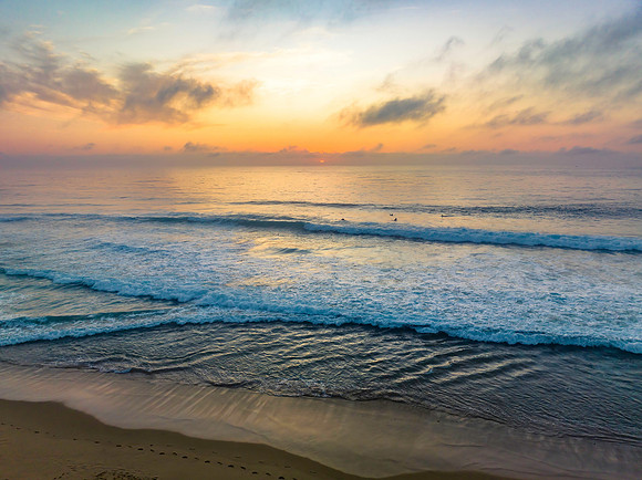 Summer sunrise at the seaside with clouds and haze
