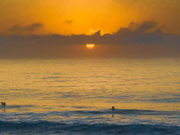 Summer sunrise at the seaside with clouds and haze