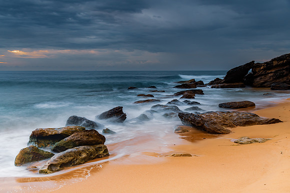 Sunrise at the seaside with rocks and beautiful diffused light b