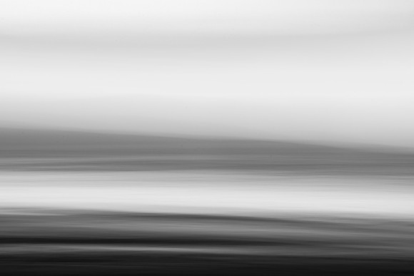 Soft abstract sunrise at the seaside in monochrome