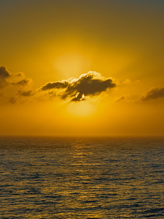 Aerial sunrise seascape with the sun, high tide and rock platfor