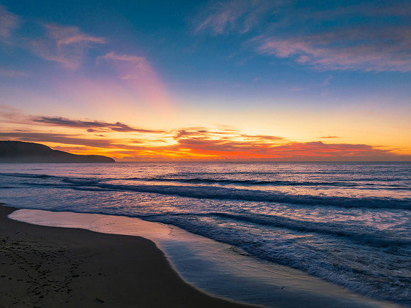 Sunrise at the seaside with pretty clouds