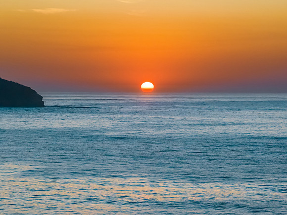 Soft hazy sunrise seascape and orange sky and full sun