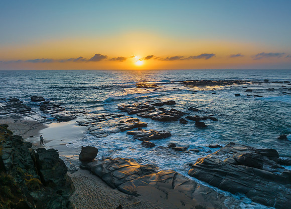 Aerial sunrise seascape with the sun, high tide and rock platfor