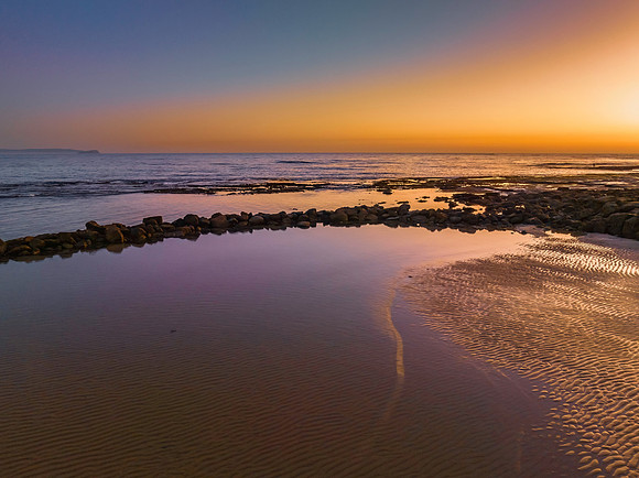 Sunrise over the sea and bay with clear skies