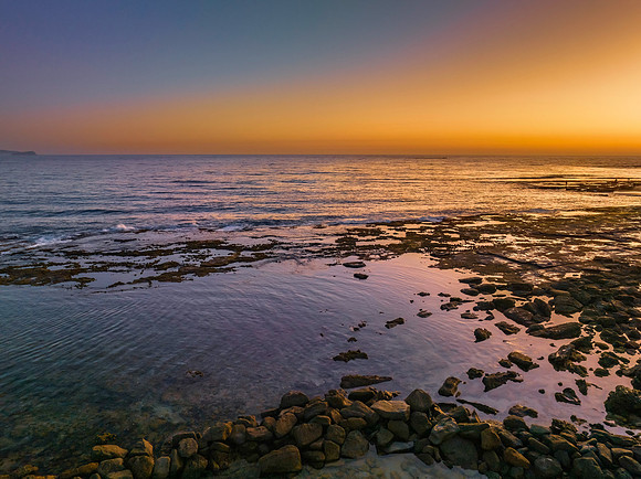 Sunrise over the sea and bay with clear skies
