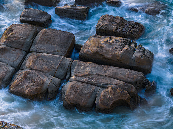 Aerial sunrise seascape with  high tide and rock platform