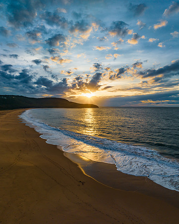 Sunrise seascape with clouds and gentle surf