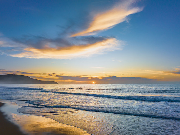 Sunrise at the seaside with pretty clouds