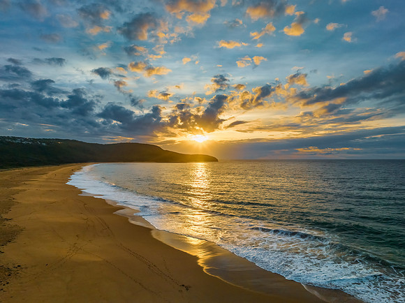 Sunrise seascape with clouds and gentle surf
